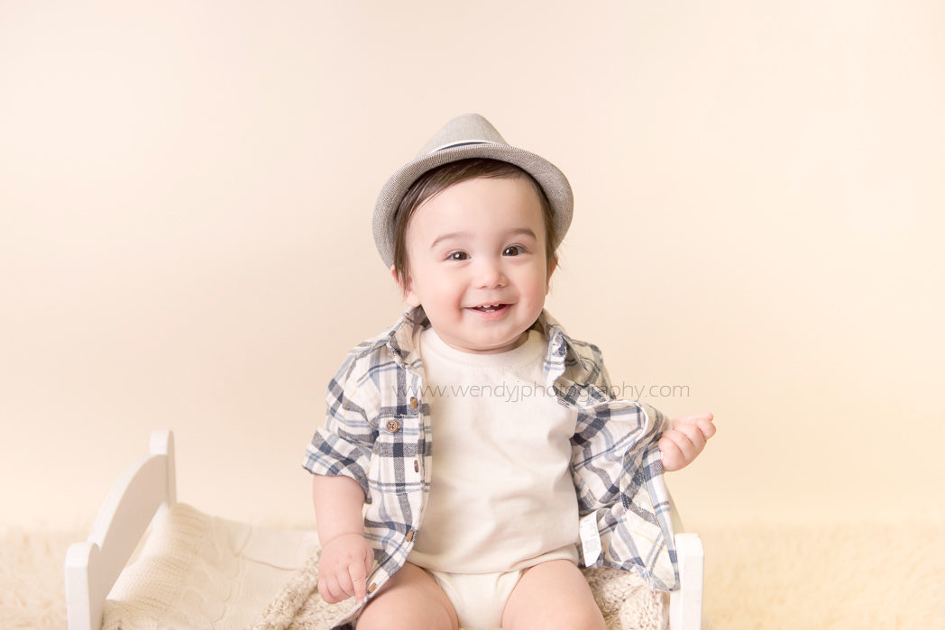 Smiling nine month old boy. Portrait by Vancouver baby photographer Wendy J Photography.