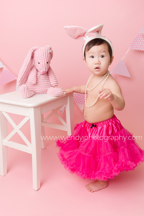 Cute 1 year old girl wearing bunny ears and tutu during a Burnaby, Vancouver B.C. child portrait photography session.