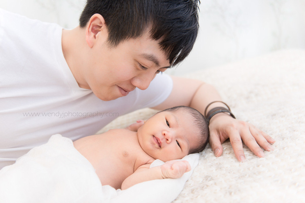 Newborn baby girl with her father.