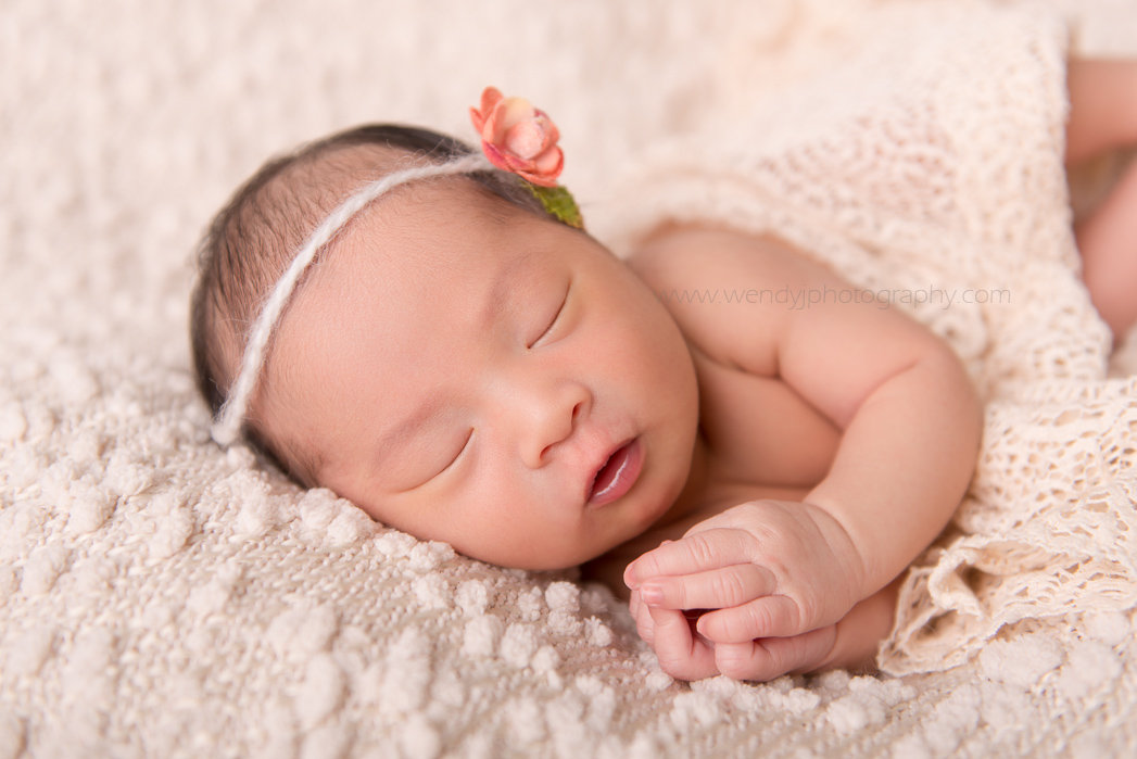 Sleeping newborn baby girl portrait by Wendy J Photography