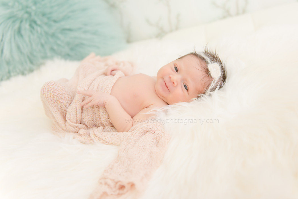 Smiling newborn baby girl.